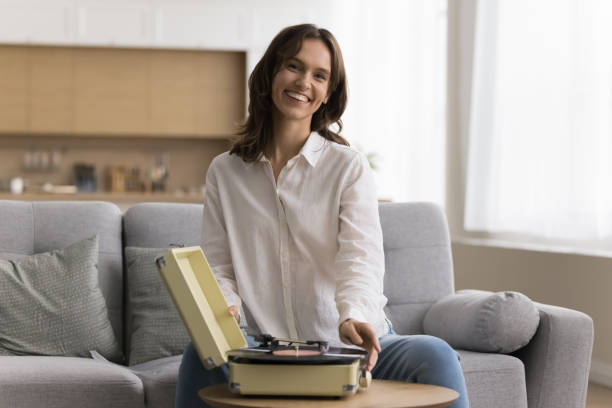istock Portrait of happy hipster girl using old phonograph 1466487909