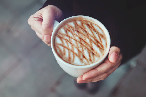 istock Woman's hand holding a cup of coffee 1466488623