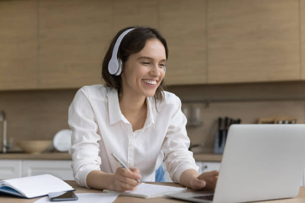 istock Happy young student woman in big wireless earphones watching workshop 1466488929