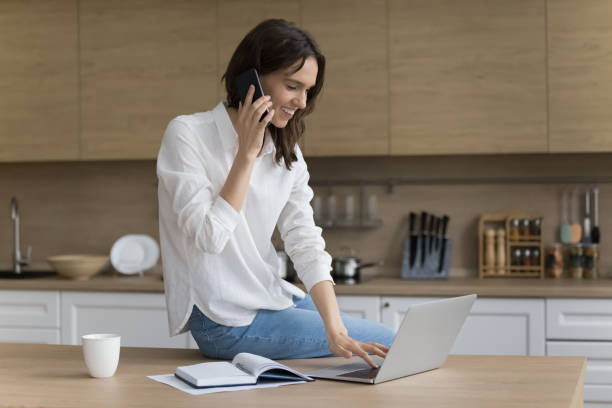 istock Positive successful freelancer woman speaking on cellphone 1466488940