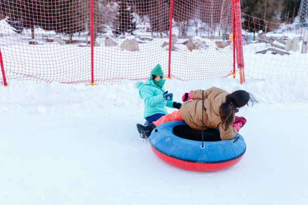 istock two children sledding on snow slope in snow bob 1466491219