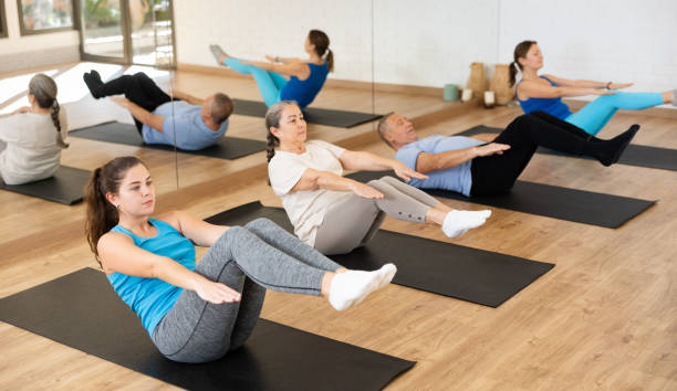 istock Young woman practicing pilates on mat in gym area 1466494236
