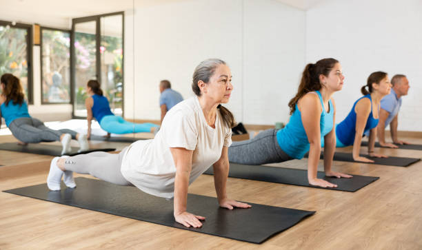 istock Elderly woman practicing pilates on mat in gym area 1466494307