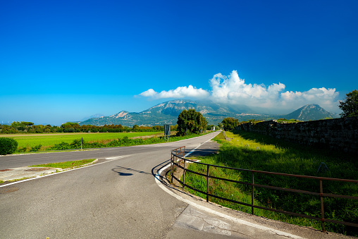 Road and view of Mount Polveracchio and Monte Soprano in Italy.