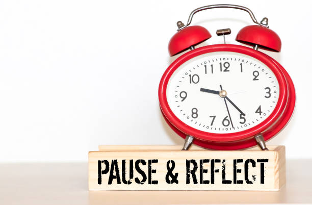 istock Written pause reflect with paper on alarm clock. Pause and reflect word with time concept. 1466498690