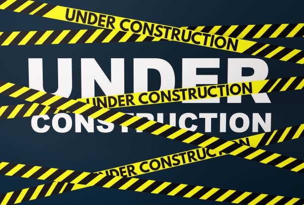 istock Yellow and black warning stripes with the inscription Under Construction. 1466501013