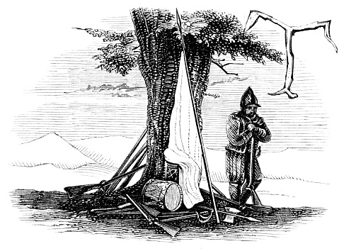 Capital T for a truce from war. A European soldier from the 16-17th century with a white flag, a drum, and rifled laid down under a tree.  Woodcut engraving published 1846. Original edition is from my own archives. Copyright has expired and is in Public Domain.