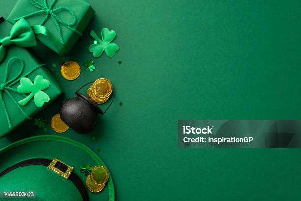 St Patricks Day Concept Top View Photo Of Leprechaun Headwear Gift Boxes Pot With Gold Coins Bowtie Clovers And Confetti On Isolated Green Background With Empty Space Stock Photo - Download Image Now