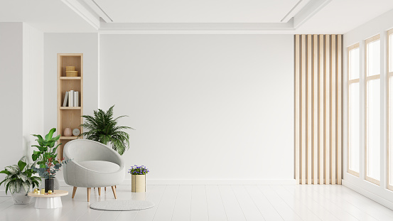 Modern minimalist interior with an armchair on empty white color wall background.3d rendering