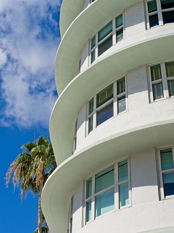 Window pattern of mixed use apartment and office complex along Lincoln Mall in downtown Miami Beach Florida. Pastel colors and curved shape suggest design similar to the art deco architecture of this more modern building.
