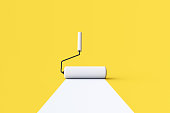 White Paint Roller with color trail over yellow background.