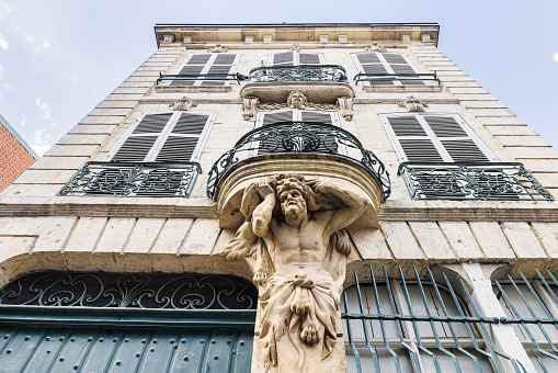 old apartment building in Amiens, France, with a historical atlas