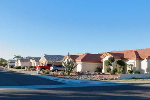Typical southwestern single family housing community  with low watering xeriscaped front yards in Phoenix, Arizona