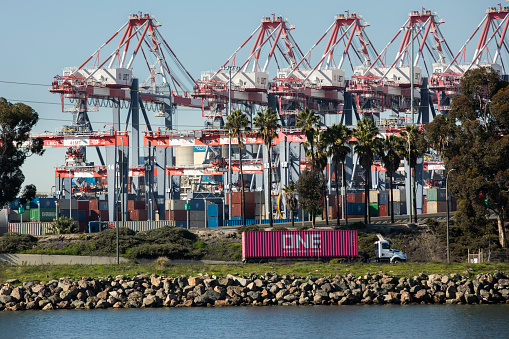 Long Beach, California, USA - July 24, 2023: Port container traffic leaves the Long Beach Container Terminal.