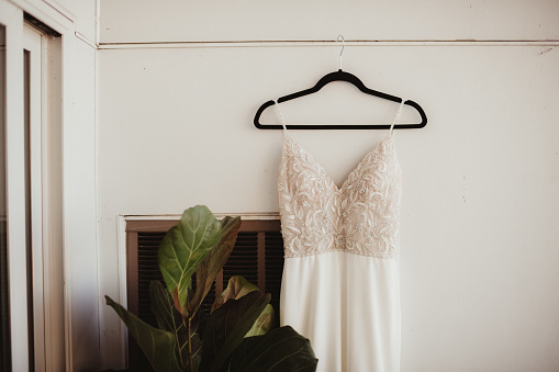 Close up of a wedding dress on a hanger