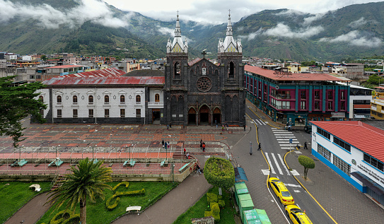 Sesquilé Colombia - August 14, 2021: The Roman Catholic church on the main square in the 400-hundred-year-old town of Sesquilé in the Department of Cundinamarca. The town was founded in 1600. It is located at an altitude of over 8,500 feet above mean sea level on the Andes Mountains. The image was shot in the morning sunlight on an overcast day. Horizontal format. Copy space.