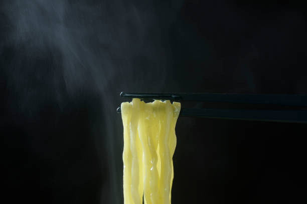 Ramen and steam lifted with chopsticks