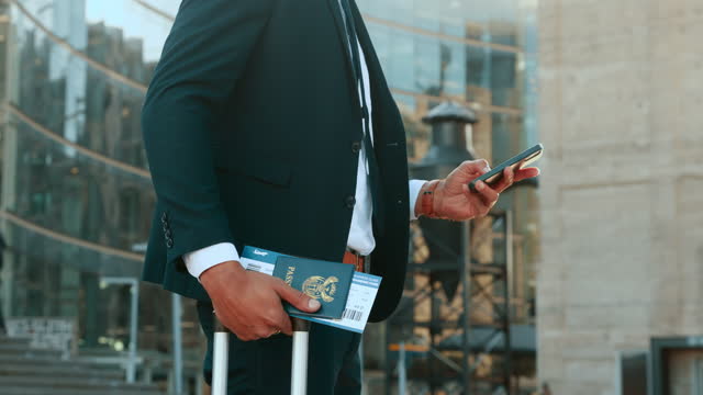 Travel, passport and phone with a business man in the city for global or international growth. Documents, ticket and 5g mobile technology with a male employee outdoor at an airport in town