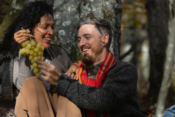 istock A couple eats grapes on a picnic in nature. 1466527701