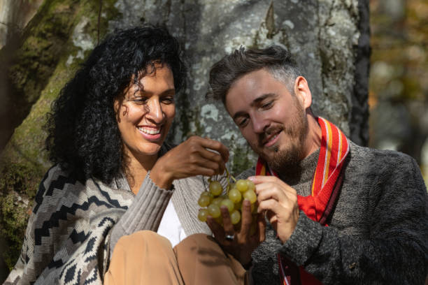 istock A couple eats grapes on a picnic in nature. 1466527705