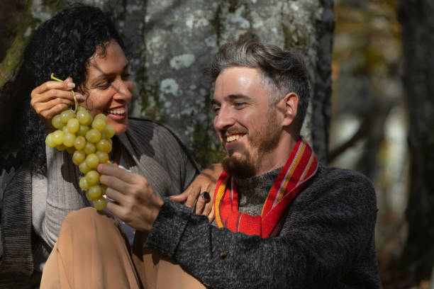 istock A couple eats grapes on a picnic in nature. 1466527706