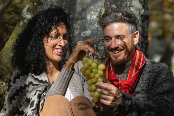 istock A couple eats grapes on a picnic in nature. 1466527709