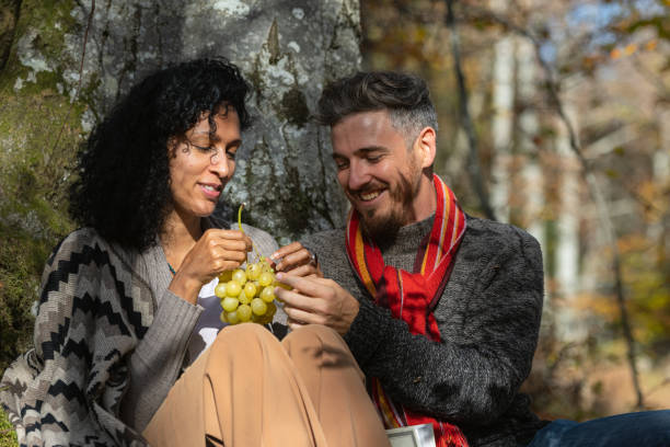 istock A couple eats grapes on a picnic in nature. 1466527712