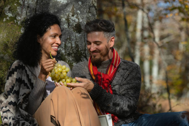 istock A couple eats grapes on a picnic in nature. 1466527717