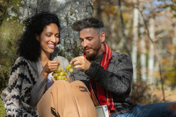 istock A couple eats grapes on a picnic in nature. 1466527719