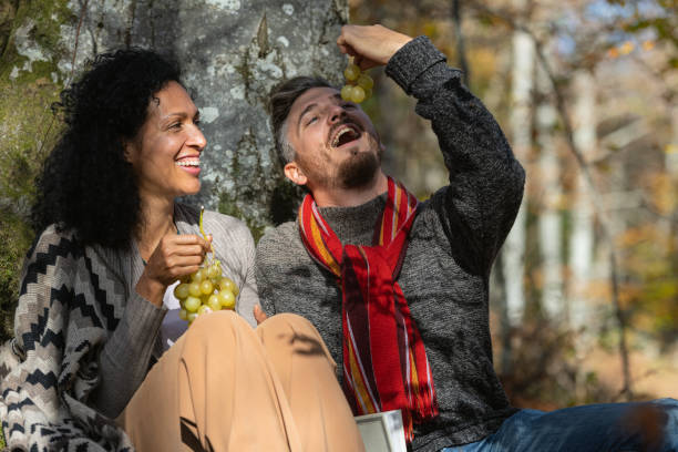 istock A couple eats grapes on a picnic in nature. 1466527723