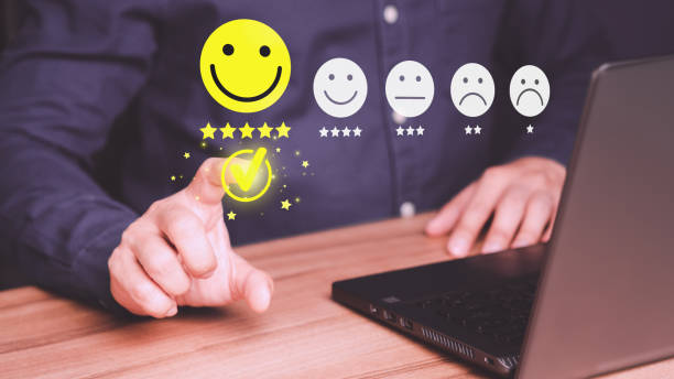 istock Man hand using computer laptop with popup five star icon for feedback review satisfaction service, testimonial. Customer service experience and business satisfaction survey. 1466538632