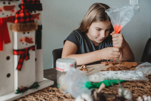 istock A girl decorating a cookie with icing for holiday 1466542923