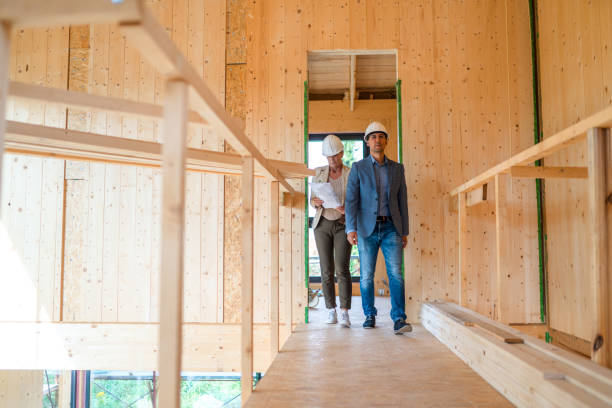 Female Contractor And Client Review New Project Contract