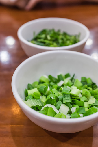 Chopped green onions in small cup