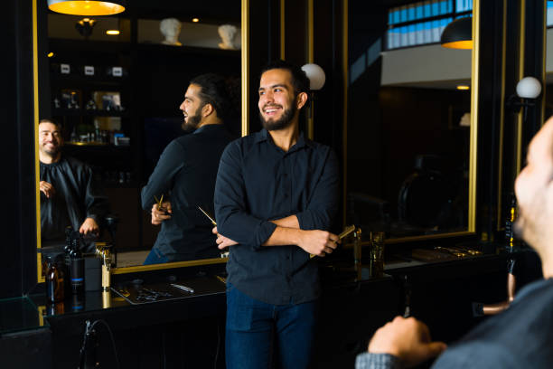 istock Happy hispanic barber working at the salon 1466543336