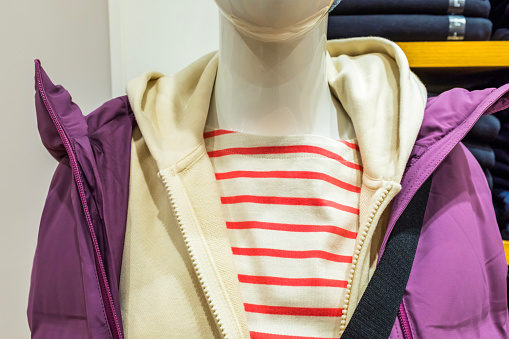 Feminine casual wear, sporty sweaters and coats on mannequins