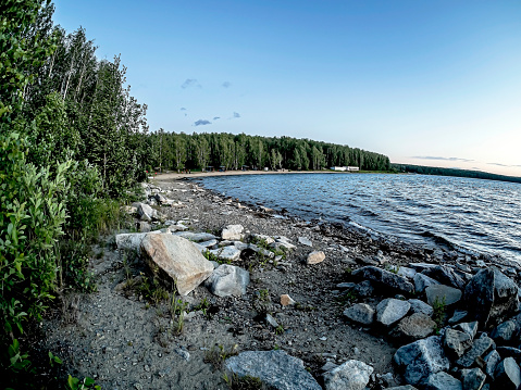 rocky shore of the lake in the morning in cloudy weather, Lake Uvildy, southern Urals, fisheye lens