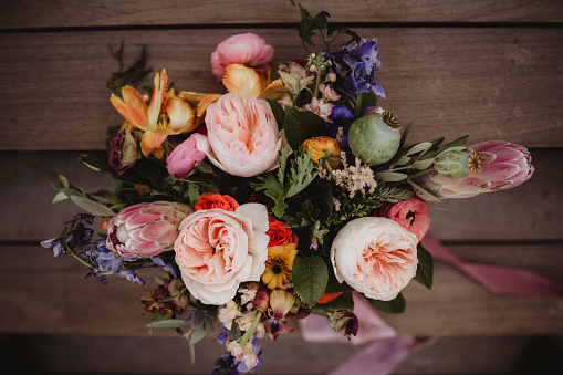 Three flower bouquet on white background. A bouquet of dried flowers wrapped in kraft paper.