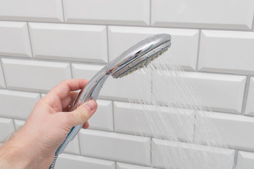 Man hand hold shower head