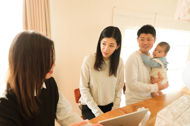 istock Advisor with Young family at home 1466554479