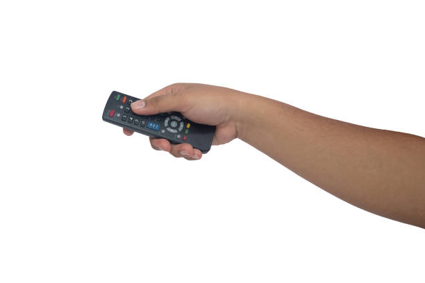 istock Asian man's hand holding television remote control isolated on white background 1466561104
