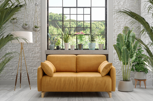 Environmentally Friendly Living Room With Yellow Sofa, Green Plants, Floor Lamp And Brick Wall