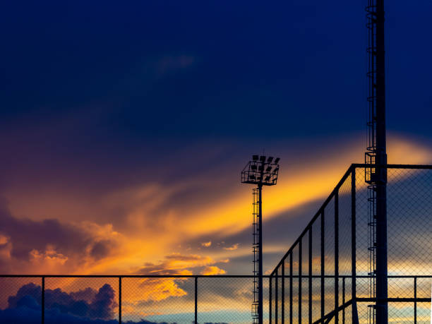 Fiery orange sunset sky. Beautiful, colorful sky at outdoor stadium. Fiery orange sunset sky. Beautiful, colorful sky at outdoor tennis court. spectrum field stock pictures, royalty-free photos & images