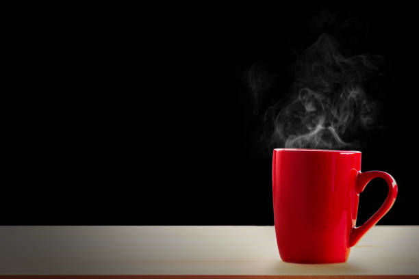 istock red mug on wooden on black background 1466564897