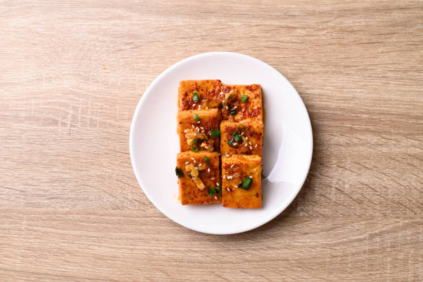 Spicy braised tofu (Dubu Jorim) on wooden background, Korean side dish, Table top view