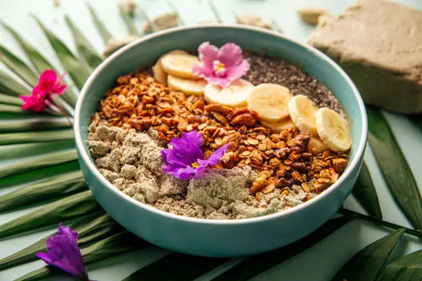 Photo of Smoothie bowl with halva bananas seeds and granola