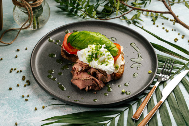 Avocado sandwich with roast beef and poached egg