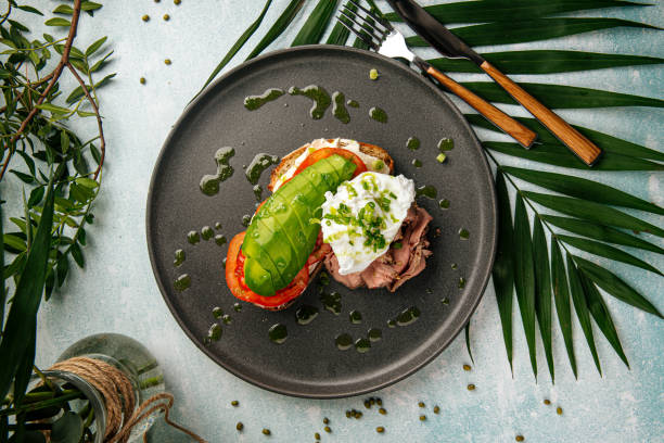 Avocado sandwich with roast beef and poached egg