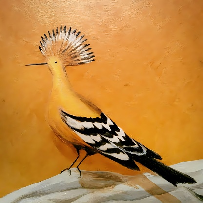 The wall painting of the bird sitting on the rock