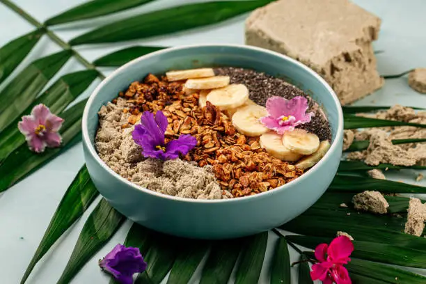 Photo of Smoothie bowl with halva bananas seeds and granola